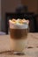 Delicious freshly made coffee latte with marshmallows stands on the table.