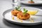 Delicious fried crab cakes garnished with parsley served on a plate with lemon wedge. Traditional food of American cuisine