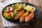 Delicious fried fish red mullet with fresh salad closeup. horizontal