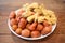 Delicious fried various meat ball. Mix asian seafood Appetizers dish isolated on brown wooden table
