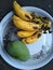 Delicious fruits ripe banana and raw mango