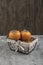 Delicious fuyu persimmon fruits placed in basket on marble surface