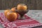 Delicious fuyu persimmon fruits on top of red tablecloth