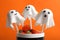 Delicious ghost shaped cake pops on orange background, closeup. Halloween celebration