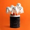 Delicious ghost shaped cake pops on orange background. Halloween celebration