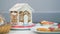 Delicious gingerbread house and colorful cookies on table