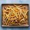 Delicious golden fries arranged on a kraft baking sheet