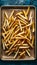 Delicious golden fries arranged on a kraft baking sheet