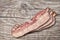 Delicious Gourmet Meaty Pork Belly Bacon Rashers Set On Old Knotted Wooden Table Surface