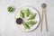 Delicious green dumplings (gyozas) served on white tiled table, flat lay