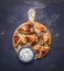 Delicious grilled chicken wings with garlic sauce on a round cutting board wooden rustic background top view