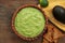 Delicious guacamole, avocados and nachos on wooden table, flat lay