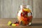 Delicious gummy bear candies in jar on wooden table