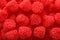 Delicious gummy raspberry candies as background, top view