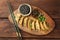 Delicious gyoza (asian dumplings) served on wooden table, top view