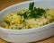 Delicious Hake on a green sauce with parsley leaves in a ceramic platter. Close up