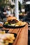 Delicious hamburgerr with french fries served on a wooden table in an outdoor cafe setting