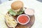 Delicious hamburgers and potato chips accompanied by warm tomato sauce.