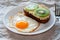 Delicious and healthy breakfast. Fried eggs and kiwi sandwich on white plate