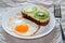 Delicious and healthy breakfast. Fried eggs and kiwi sandwich on white plate