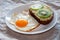 Delicious and healthy breakfast. Fried eggs and kiwi sandwich on white plate