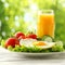 Delicious and healthy breakfast plate with fried egg, veggies, and orange juice on white table