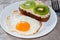 Delicious and healthy breakfast. Scrambled eggs and kiwi sandwich