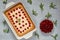 Delicious healthy dessert - cherry pie in the baking dish on the gray kitchen background. Homemade summer cheesecake