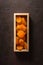 Delicious and healthy dried apricots. Freshly dried. On a brown background in wooden box.