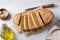 Delicious healthy gluten free lentil bread without flour with sesame seeds in a white baking dish on a light gray background.