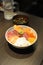 Delicious and healthy sashimi kaisendon set in a bowl with raw fish, urchin, seafood and rice in a restaurant in Japan