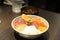 Delicious and healthy sashimi kaisendon set in a bowl with raw fish, urchin, seafood and rice in a restaurant in Japan