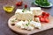 Delicious healthy sheep or goat feta cheese. Chunks of cheese on a wooden board