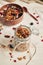 Delicious healthy vegan granola with pecan nuts in a fruity bowl with yogurt on a white table