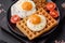 Delicious hearty breakfast consisting of a fried egg, Belgian waffle