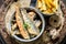 Delicious herring fish and chips with herbs and salt