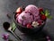 Delicious homemade berry ice cream with fresh fruit and edible flowers