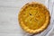 Delicious homemade Canadian Tourtiere Meat Pie on a white wooden table, top view. Flat lay, overhead, from above. Copy space