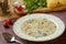 Delicious homemade chicken soup with traditional bulgarian liaison, noodles, parsley, bay leaf and grated carrots. Selective focus