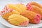 Delicious homemade chocolate dipped madeleine on white table background