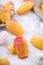 Delicious homemade chocolate dipped madeleine on white table background