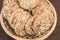 A delicious homemade cookie with cereals and seeds lies in a wicker basket