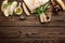 Delicious homemade italian ciabatta bread with olive oil and olives on wooden rustic background, above view, space for text