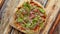 Delicious homemade Italian prosciutto and rucola pizza placed on wooden background