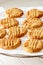 Delicious homemade peanut butter cookies on cooling rack. White wooden background. Healthy snack concept.