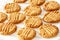 Delicious homemade peanut butter cookies on cooling rack. White wooden background. Healthy snack concept.