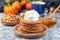 Delicious homemade pumpkin pancakes served with whipping cream, walnuts and honey, autumn decoration,  horizontal