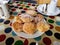 Delicious homemade scones on a rural decorated table along with a cup of tea and milk