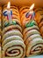 Delicious homemade swiss roll slices with jam and number candles served as a birthday cake