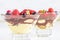 Delicious Homemade tiramisu with berries on white background. Shallow depth of field